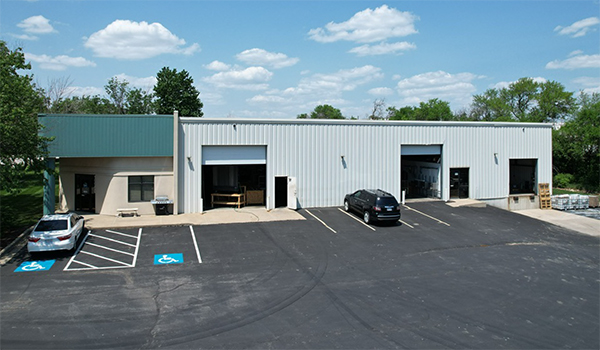 photo of 1 metal building with car stalls.